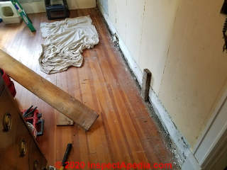 Removing baseboard trim to give wiring space in an older home (C) Daniel Friedman at InspectApedia.com