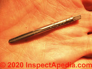 Tapping bit used to cut threads into a drilled-opening (C) Daniel Friedman at InspectApedia.com