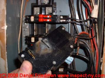 Photo of a Zinsco type circuit breaker with arc burning (C) Daniel Friedman at InspectApedia.com