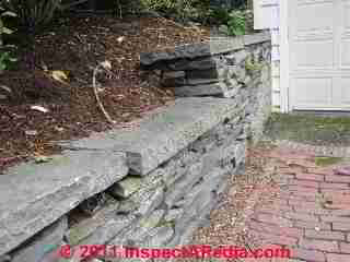 Retaining wall damage © D Friedman at InspectApedia.com 