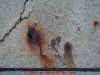 Red rust stains on a concrete sidewalk Vassar College Poughkeepsie NY (C) Daniel Friedman at InspectApedia.com