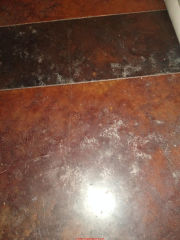 White spots on brown-stained concrete floor (C) InspectApedeia.com Misty