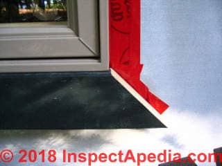 Window frame taped to housewrap (C) Daniel Friedman at InspectApedia.com