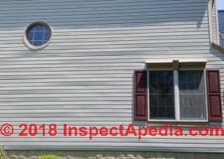 Horizontal bulges in vinyul siding installed in 2017 -  expands in sunlight (C) InspectApedia.com Sue
