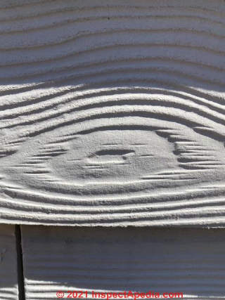 Knot pattern identifies this fiber cement siding manufacturer (C) InspectApedia.com Megan