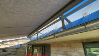 motorized patio awning installed from on top of roof (C) InspectApedia.com DJF