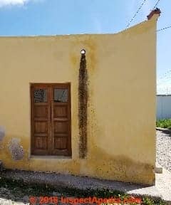 Black algae stains below roof drain on stucco wall in Pozos, Guanajuato, Mexico (C) Daniel Friedman