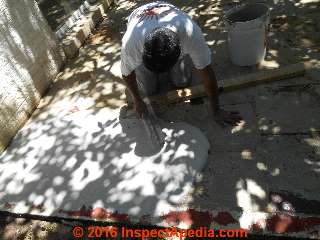 Pouring leveling concrete layer to repair a damaged concrete patio (C) InspectApedia.com