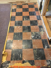Red and black asphalt asbestos floor tile (C) InspectApedia.com