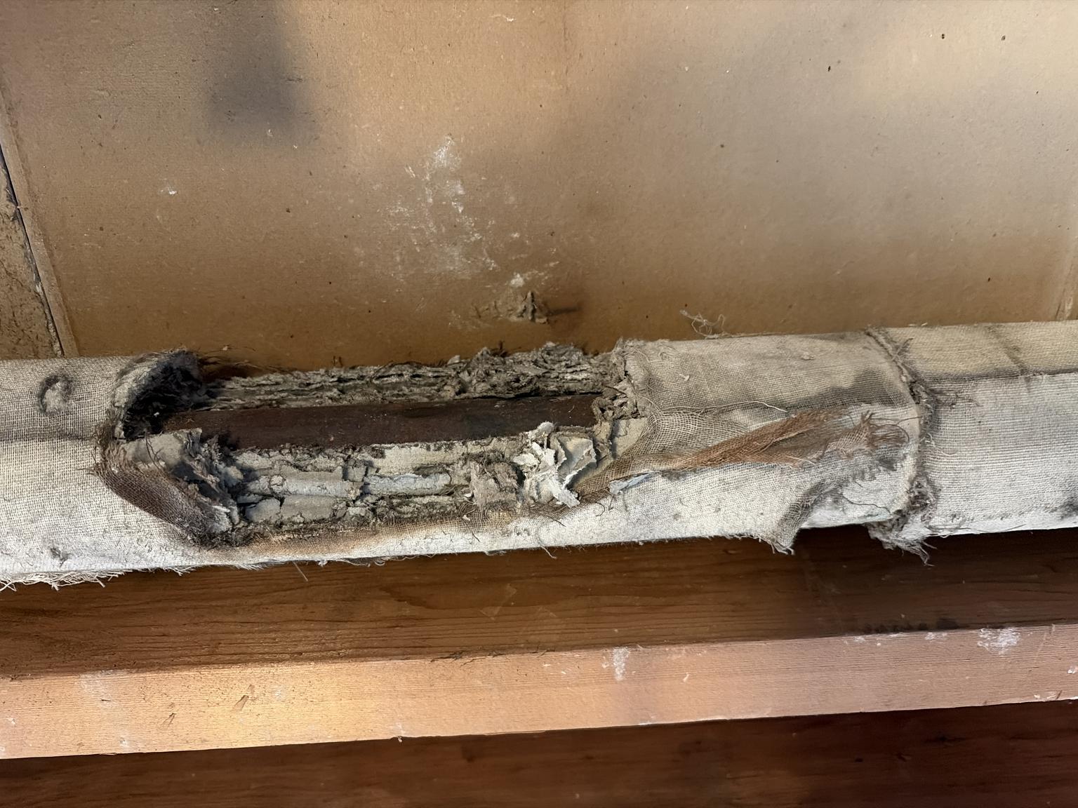 Asbestos pipe insulation in a 1929 New England Home - (C) InspectApedia.com Trish