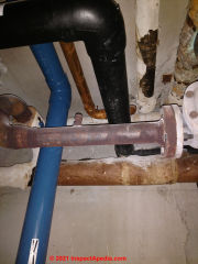 Fiberglass pipe insulation at left and other Asbestos suspect pipe insulation (C) InspectApedia.com AQ