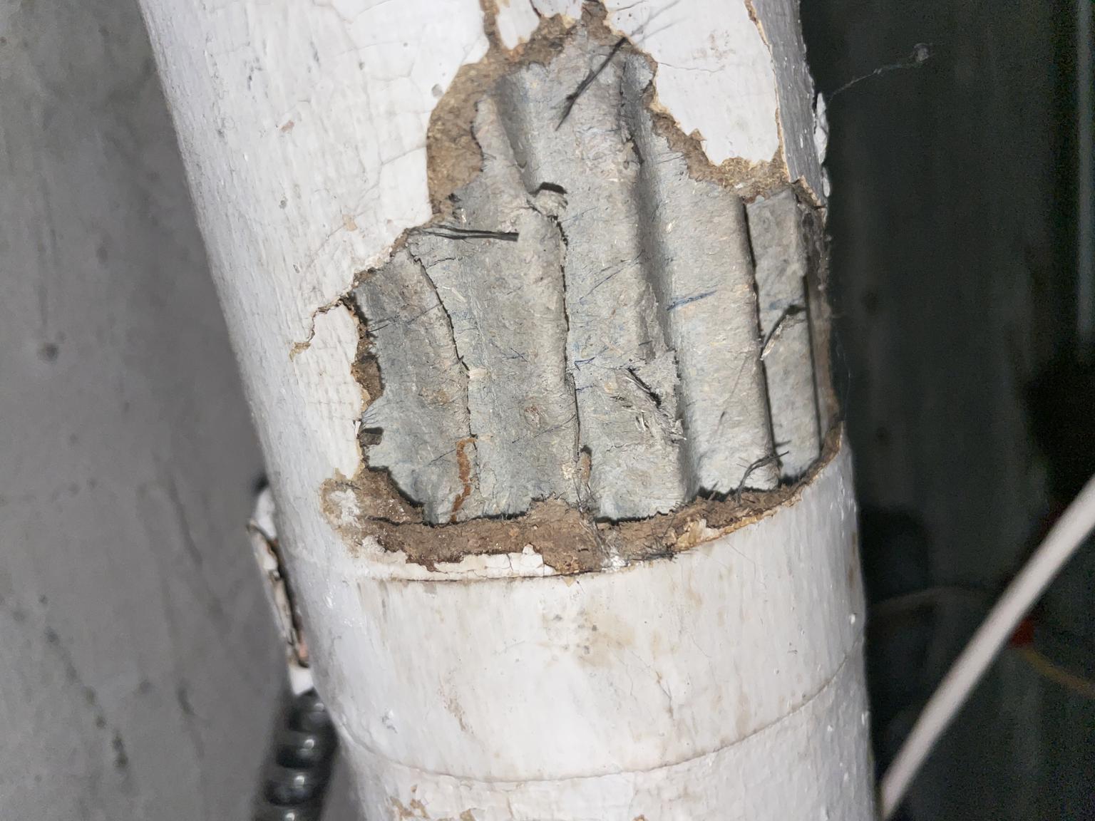 Asbestos insulation - corrugated paper asbestos - pipe insulation (C) InspectApedia.com J