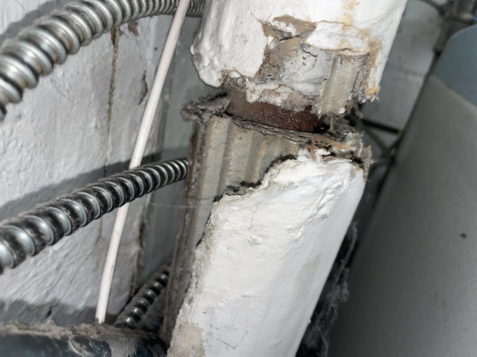 Corrugated asbestos paper pipe insulation (C) InspectApedia.com J