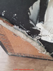Possible asbestos in putty or caulk onold mirror (C) InspectApedia.com Putty