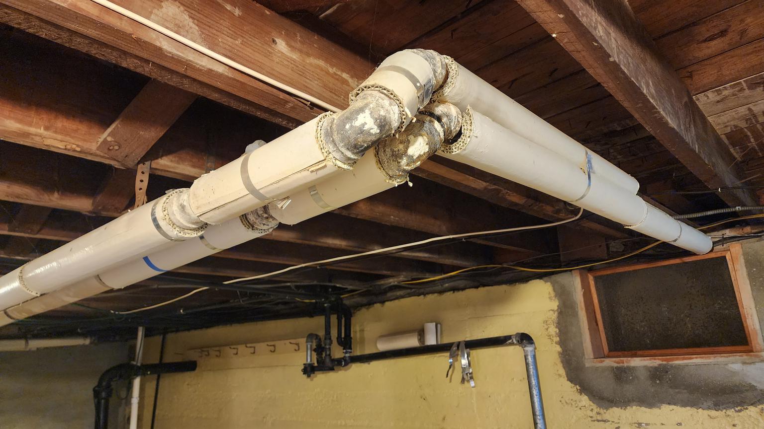 Asbestos insulation on and also lost from pipes (C) InspectApedia.com Marcella