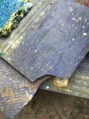 Blue asphalt or vinyl asbestos floor tile (C) Inspectapedia.com Jj