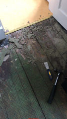 Poor condition floor with Asbestos suspect flooring & backer (C) InspectApedia.com  Anabel