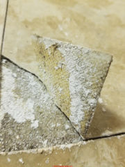 White backer vinyl floor tile with apparent fiberglass might still contain asbestos - more research needed (C) InspectApedia.com Dave