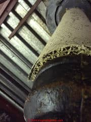 Asbestos insulation on a roof drain (C) InspectApedia.com reader provided