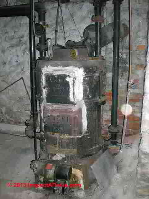Hardcast asbestos on heating boiler © D Friedman at InspectApedia.com 