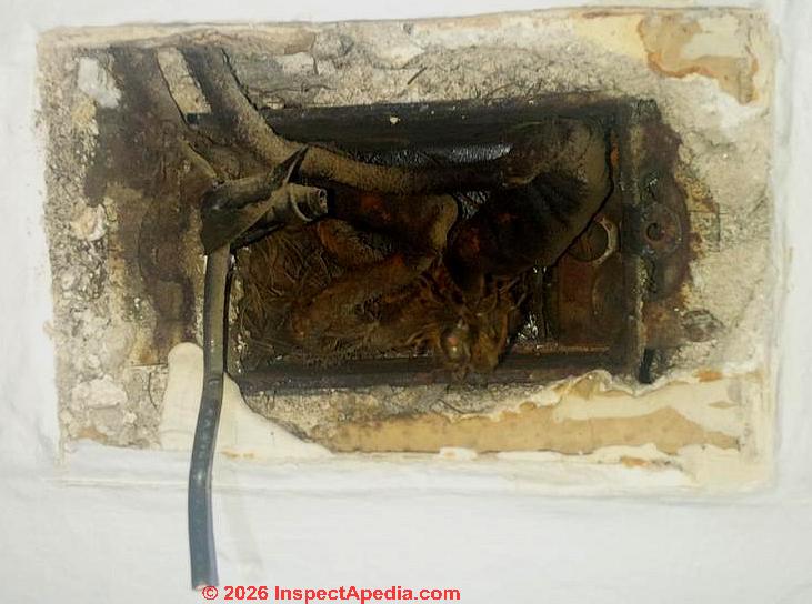 Electrical wire insulation material in a 1919 building (C) InspectApedia.com Cat