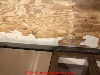 Improper and incomplete asbestos suspect flooring remains (C) InspectApedia.com Beth