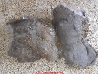 Dark deposits on fiberglass insulation not mold (C) InspectApedia.com Tim