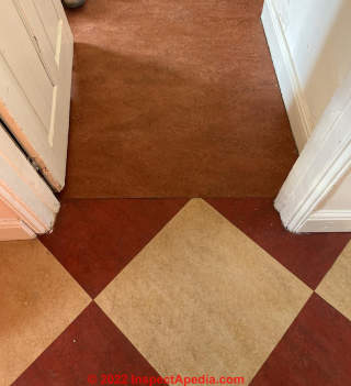 Red and cream floor tiles and red sheet flooring (C) InspectApedia.com Lengman