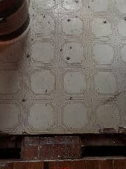 Unknown floor tile might contain asbestos - check age of floor and building (C) InspectApedia.com Anon