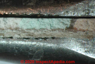 Marble chip resilient flooring known to contain asbestos (C) Daniel Friedman at InspectApedia.com Two Harbors MN
