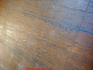 Brown wood grain vinyl floor tiles (C) InspectApedia.com  Rebekah 