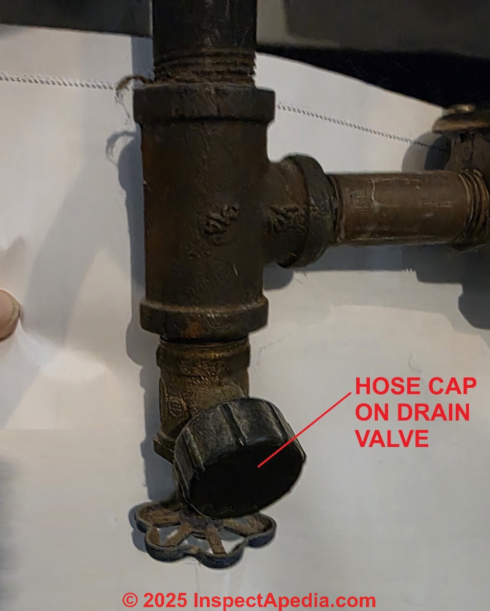 A hose cap on a leaky boiler or water heater tank drain can stop a drop and also improve child safety (C) Daniel Friedman at InspectApedia.com