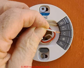 Double & twist the tiny C-wire kit wire if it's too thin - to get a better connection at the smart thermostat (C) InspectApedia.com