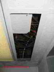 Photograph of commercial air conditioning system ceiling plenum with debris