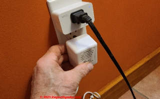 Plugging the Nest C wire adapter back into the wall receptacle (C) InspectApedia.com