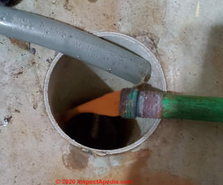 Orange red water discharged from radiant heat floor tubing (C) InspectApdia.com Mark