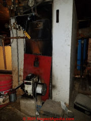 Steam boiler in terrible shape and lacking working space (C) Daniel Friedman at InspectApedia.com