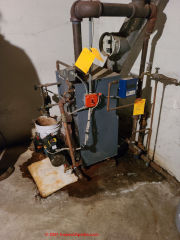 Leaks at this 1980s Weil McLain cast iron steam boiler ultimately destroyed it, leading to an urgent need for a costly boiler replacement (C) Daniel Friedman at InspectApedia.com