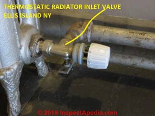 Thermostatic inlet valve controlling a steam heat radiator at Ellis Island NY (C) Daniel Friedman at InspectApedia.com