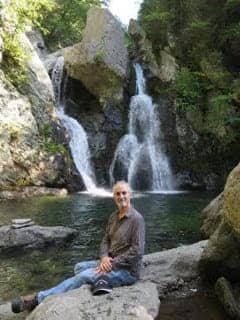 Photo of author sitting by Bash Bish Falls in MA