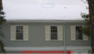 Melting snow at ridge of this Minnesota home is a tip-off of un-wanted heat loss into attic (C) InspectApedia.com and hankeyandbrown.com images used with permission