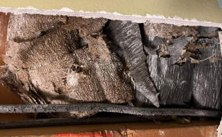Old and crumbling crepe paper insulation (C) InspectApedia.com Jessica