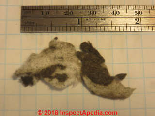 White and black or dark brown fibrous insulation needed to be identified (C) Inspectapedia.com JVA