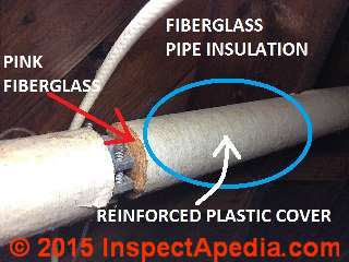 Fiberglass insulation on heating pipes (C) InspectAPedia.com