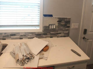 Backsplash edge termination in free areas not abutting a cabinet or countertop (C) InspectApedia.com A Church