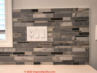 Ceramic tile kitchen backsplash installation completed - edge coverings at open sides (C) InspectApedia.com A Church