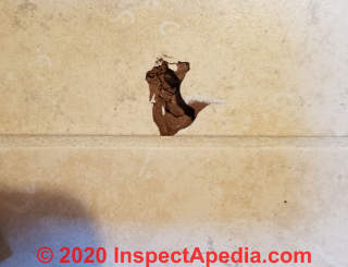 Broken ceramic tile before repair (C) Daniel Friedman at InspectApedia.com