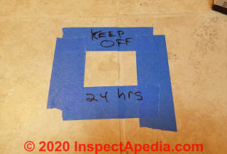 Mark off the area of repair and protect it during curing of the tile grout (C) Daniel Friedman at InspectApedia.com