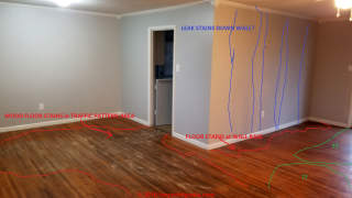 Dark stains on wood floor may hint at a leak history, hidden old, or something else (C) InspectApedia.com CH