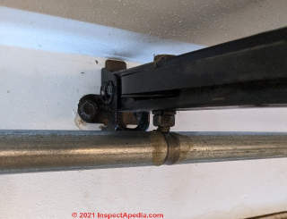 Unsafe torsion bar type automatic garage door operator (C) InspectApedia.com rw